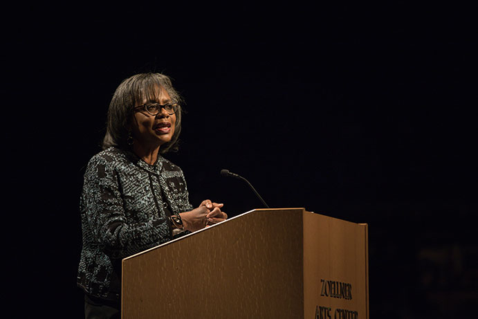 Anita Hill speaking at podium