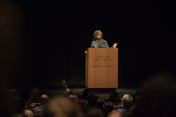 Anita Hill speaking at a podium