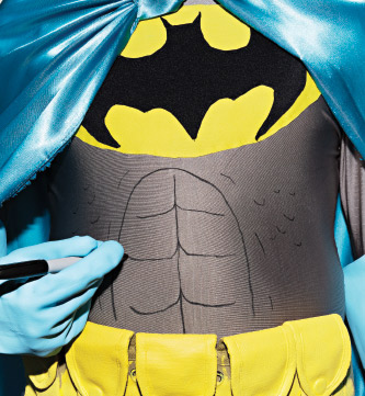 Batman drawing abs on with a sharpie