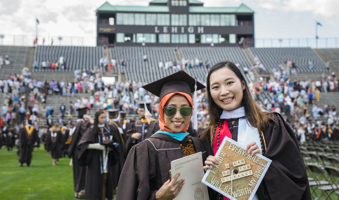 Two female graduates at Lehigh commencement