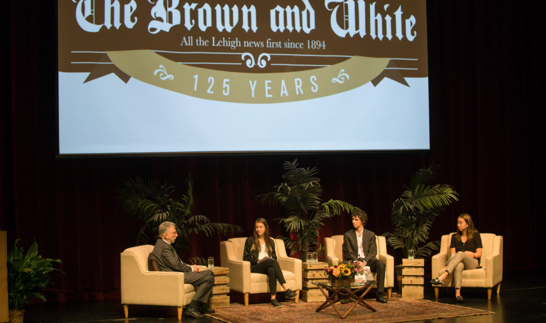 Marty Baron speaks with editors from The Brown and White on stage in Baker Hall