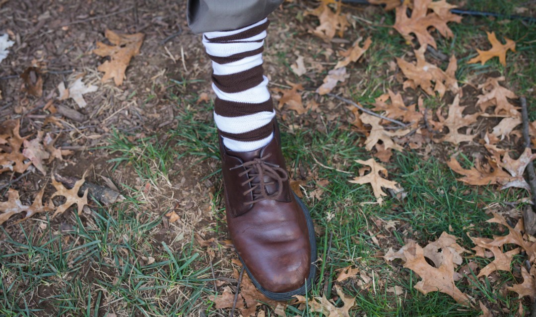Lehigh brown and white socks on a foot at Brown & White BBQ. 