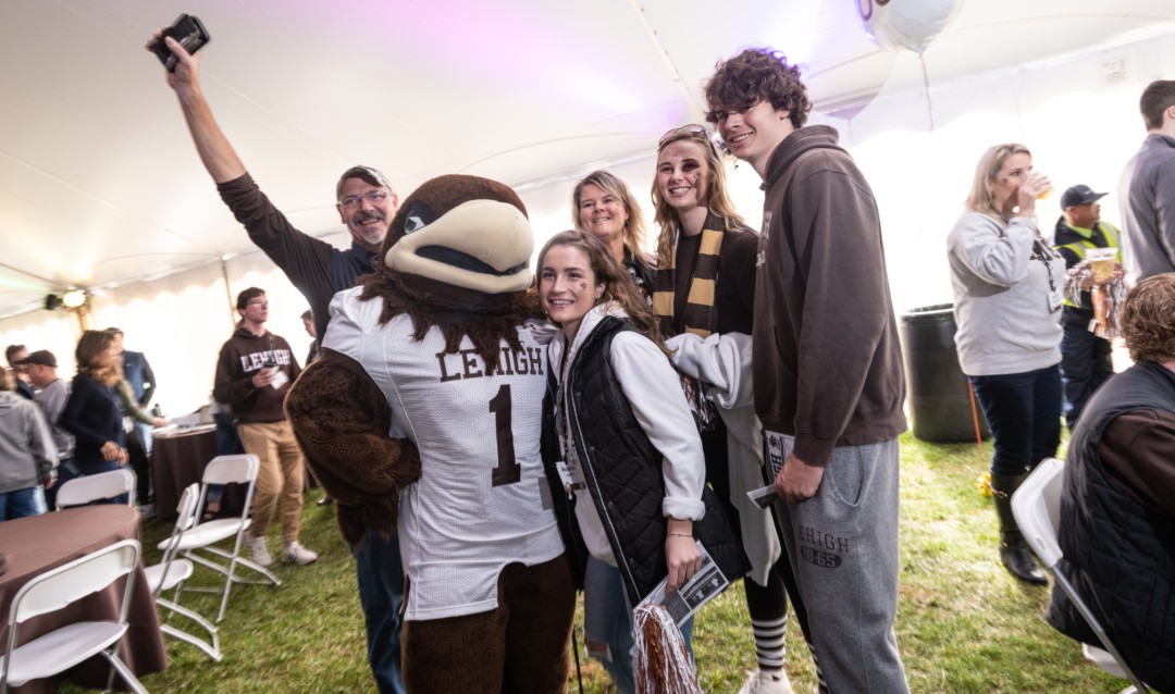 Lehigh University mascot Clutch poses with family at football tailgate
