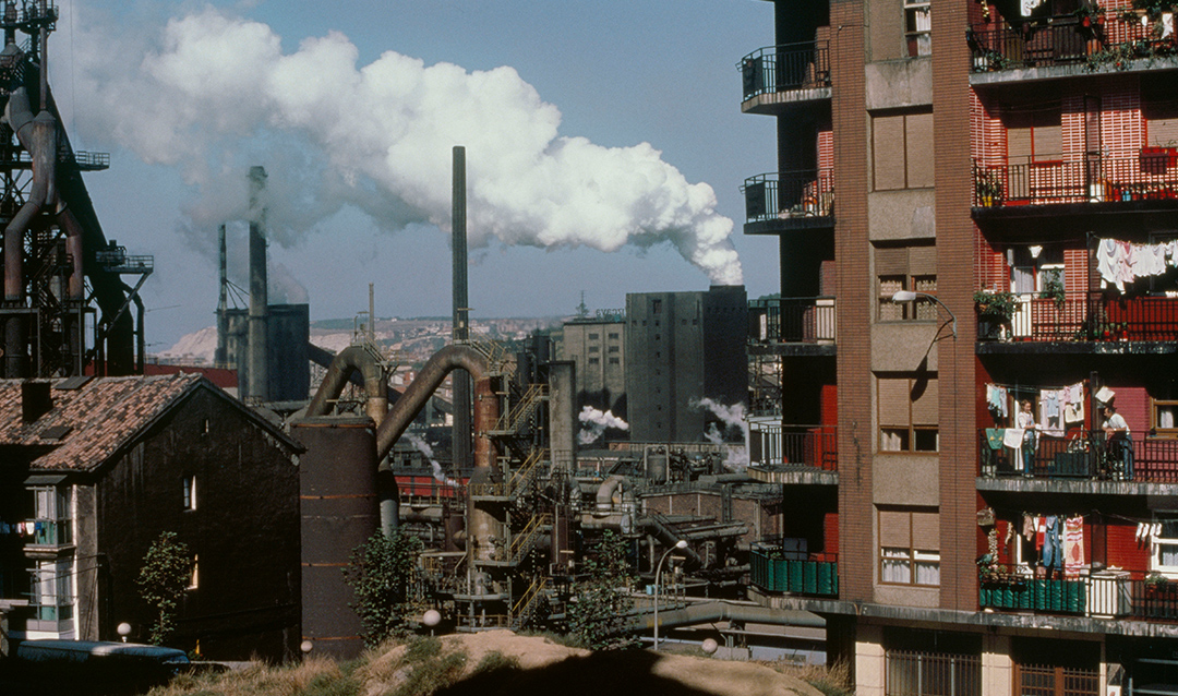 Photograph of smoke stacks in city with polluted air 