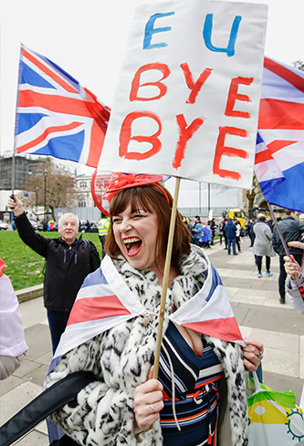 Pro-Brexit woman holds sign at rally