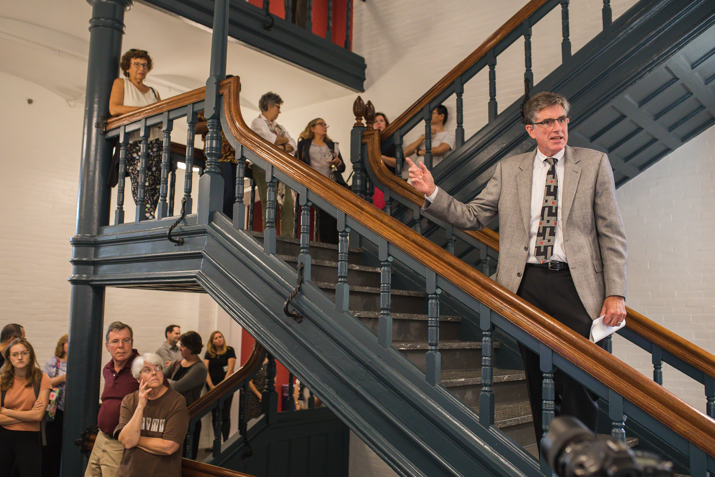 Lehigh Provost Pat Farrell speaks on the staircase at the open house for the newly renovated Chandler-Ullmann Hall.