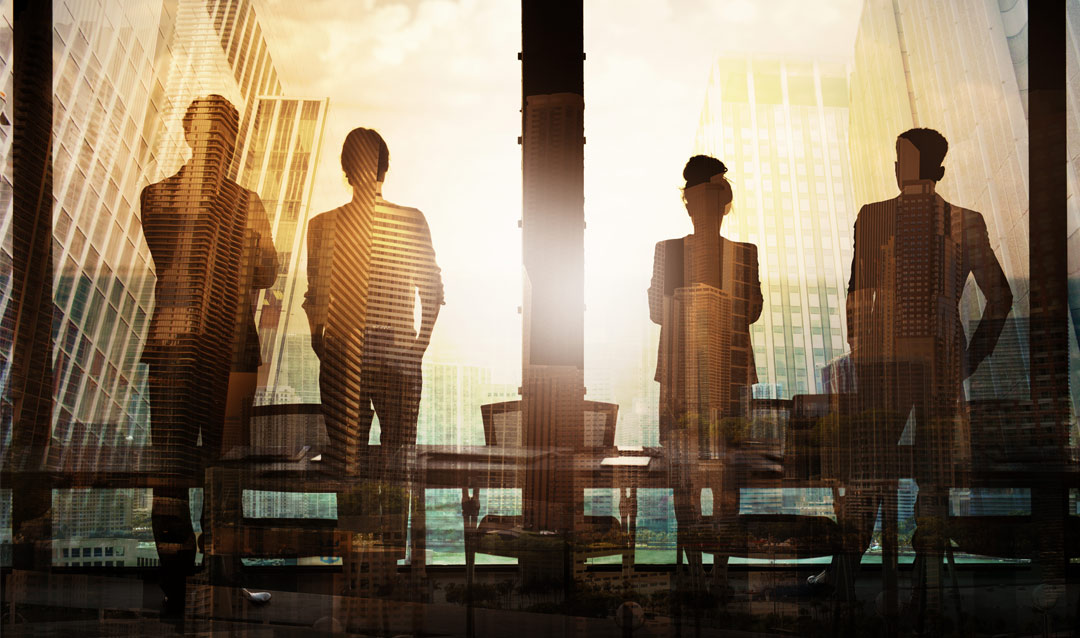 Silhouettes, including a woman, in an office