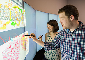 Two students at an interactive whiteboard