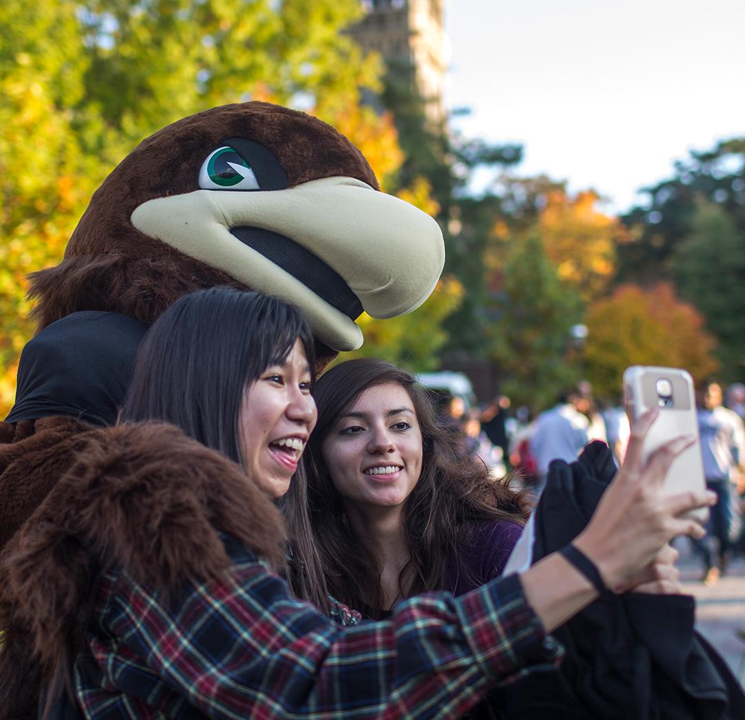 Mascot taking selfie with students
