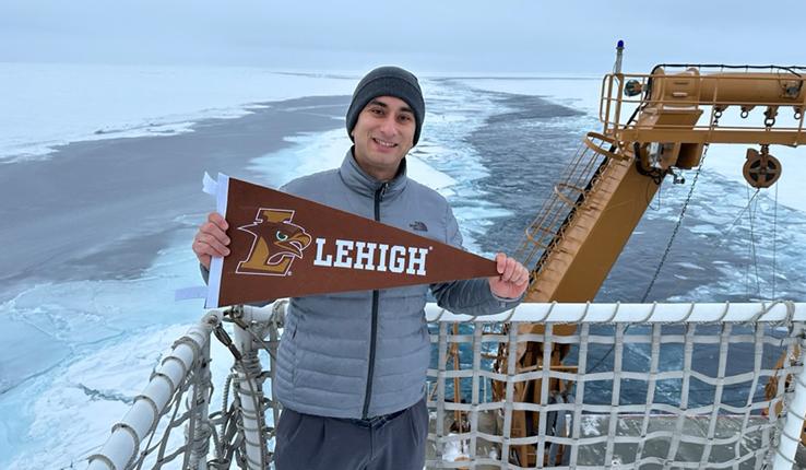 Eugene Vivino ’16 holds a Lehigh sign at the Arctic