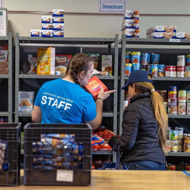 Two volunteers working at a food bank