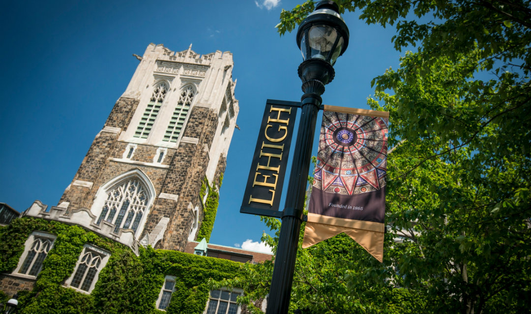 Lehigh University's Alumni Memorial Building with Lehigh flag hanging in front