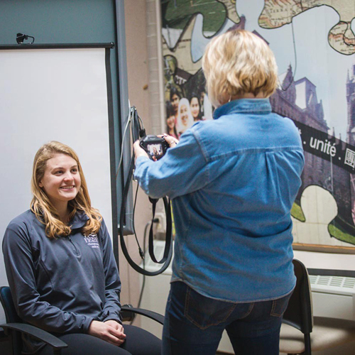 Student getting passport photo taken