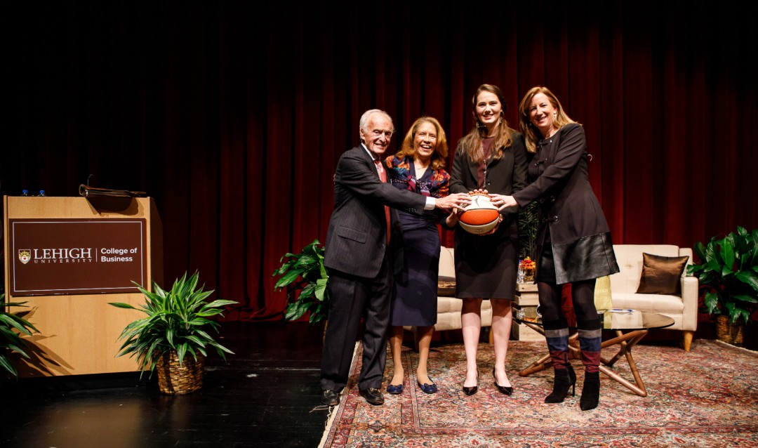 Donald M. Gruhn; Georgette Chapman Phillips, Kevin L. ’84 ’13P and Lisa A. ’13P Clayton Dean of the College of Business; Mary Clougherty; and Cathy Engelbert stand together on stage holding a basketball at Lehigh University