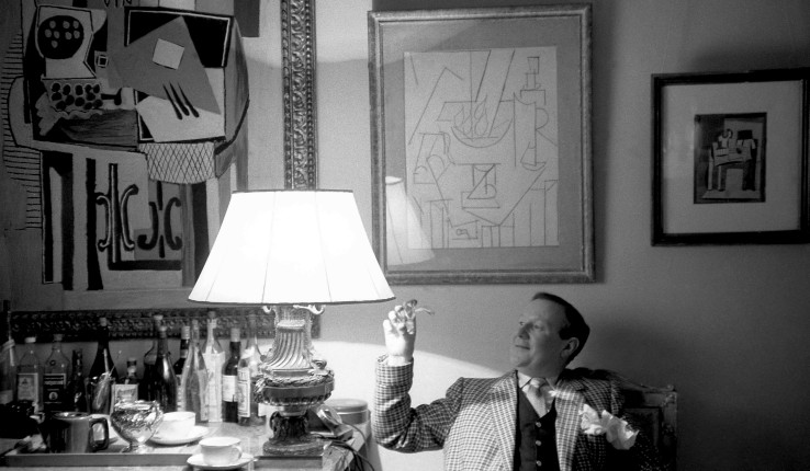 Douglas Cooper at his home in Argilliers, France, in front of Picasso works