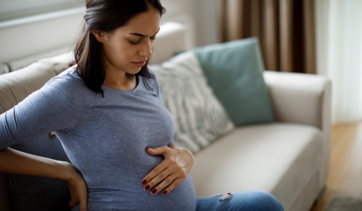 Pregnant woman touching stomach