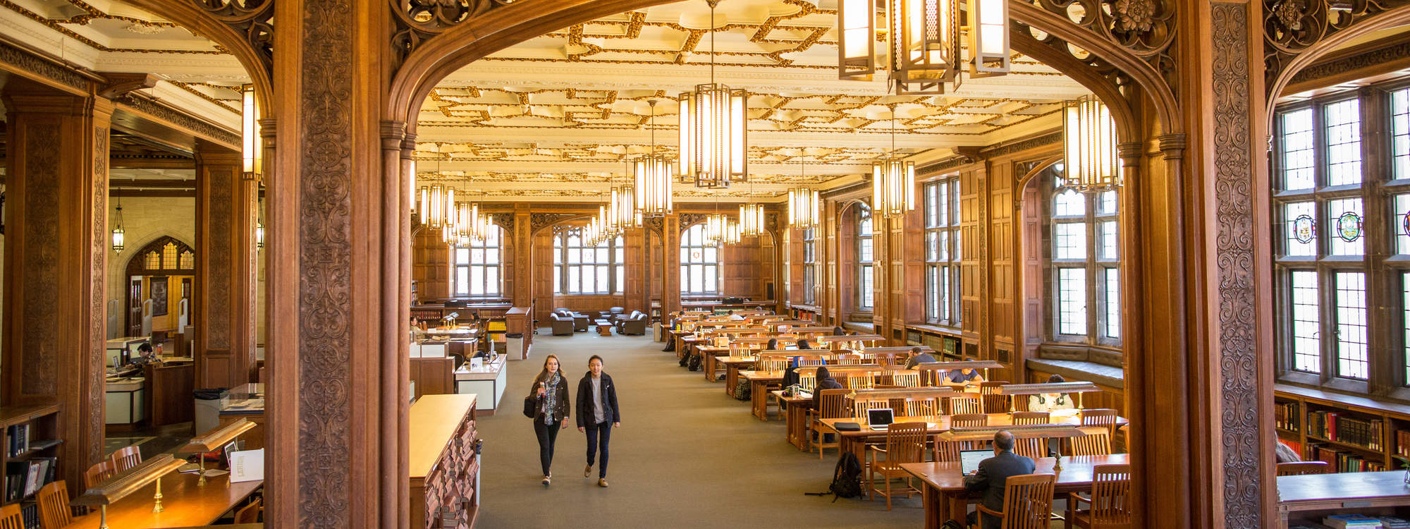 Two students walking in Linderman Library