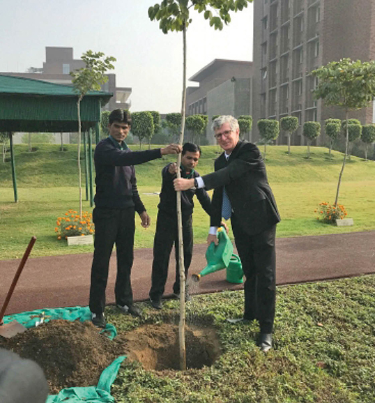 Simon plants a tree in India