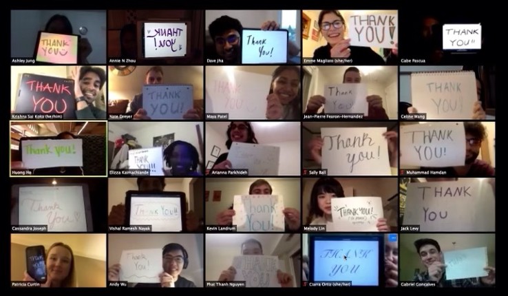 Zoom call with people holding thank you signs