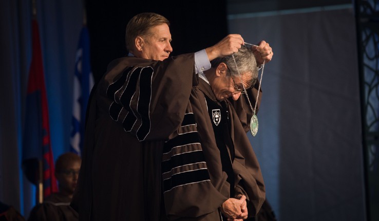 Lehigh Board of Trustees Chair Kevin Clayton ’84 ’13P presents Lehigh President Joseph J. Helble ’82 with the Chain of Office Medallion of the university