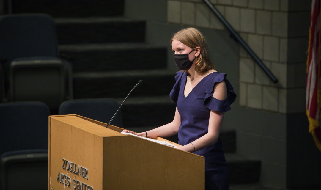 Nora Abbott speaks at podium