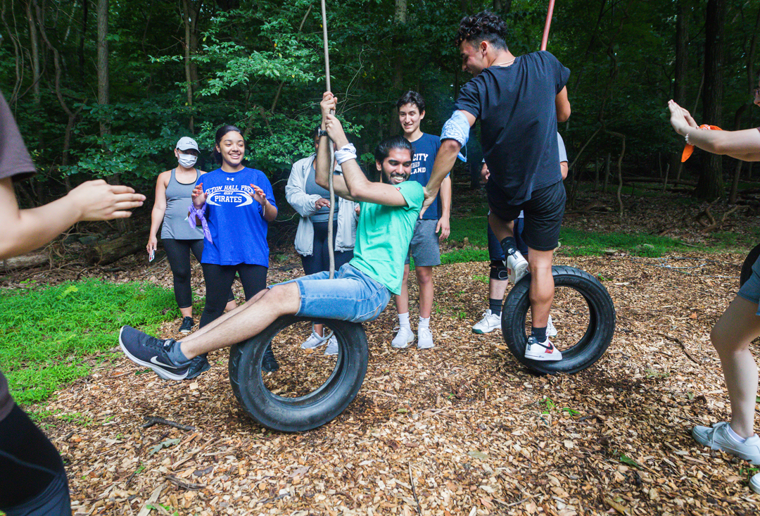Students on tire rope swings