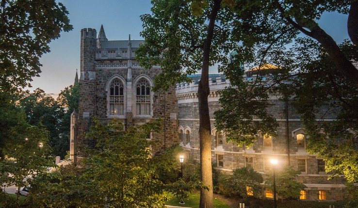 Lehigh University campus at dusk with Linderman Library in background and lights in foreground