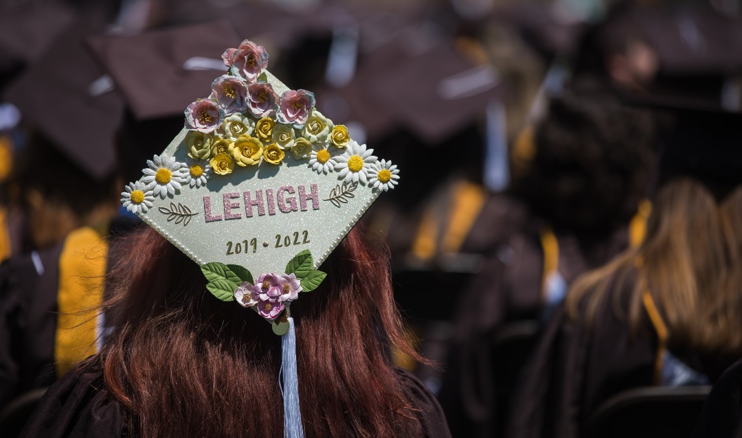 graduates leave messages on their mortarboards