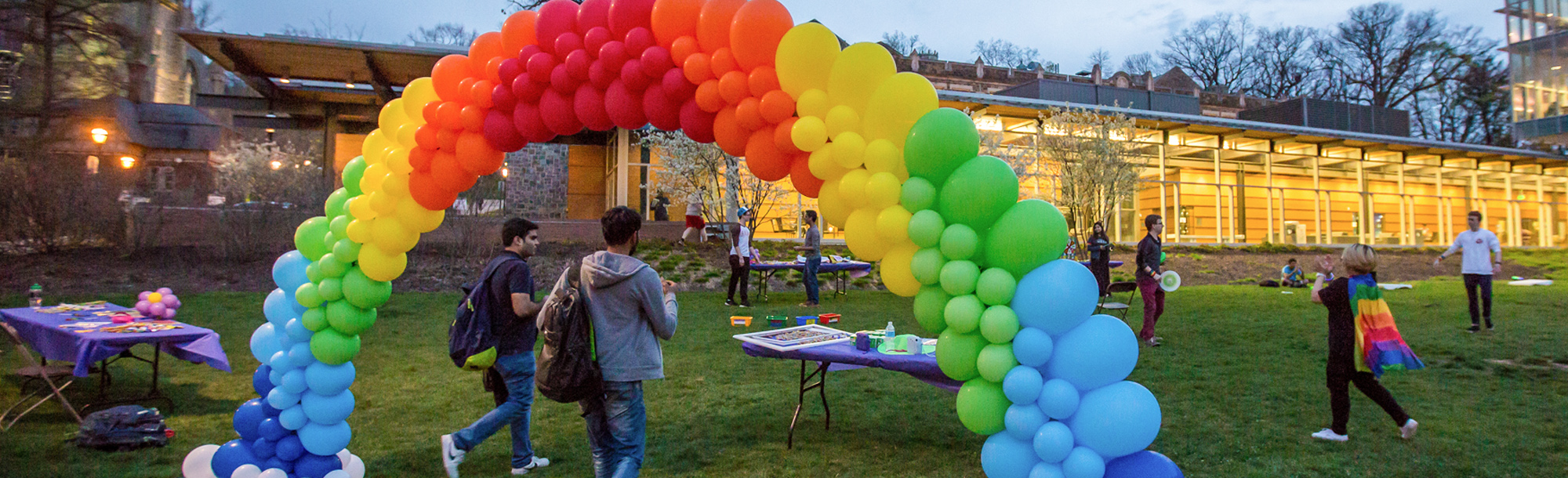 A rainbow balloon arch at a campus event