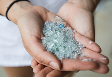 A close up of hands holding pieces of plastic