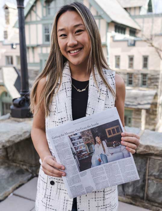 Annie Wu Henry ’18  with a copy of The New York Times