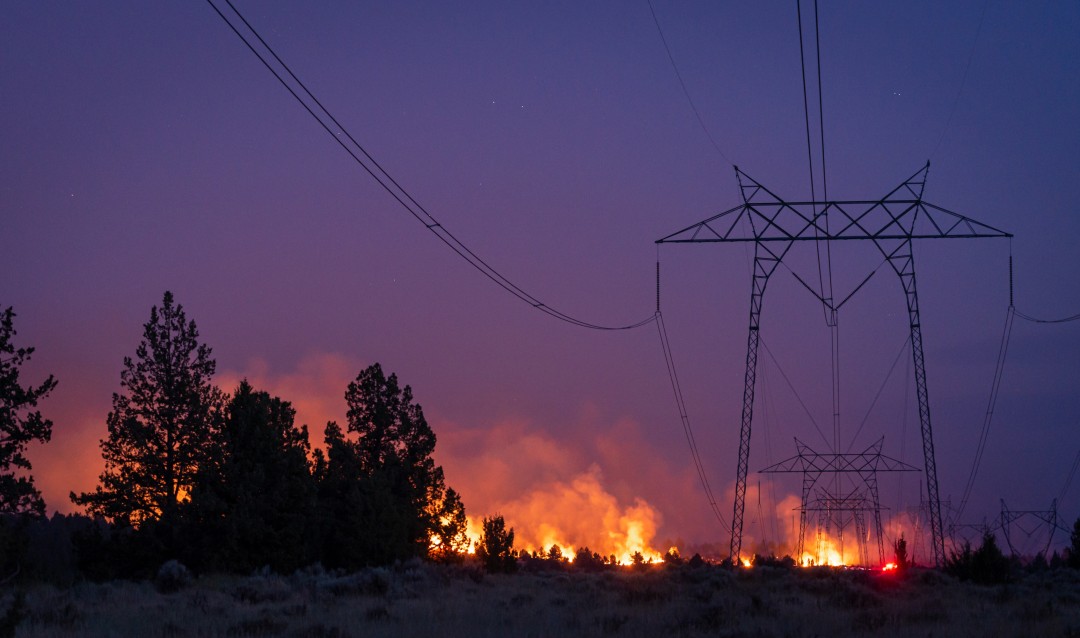wildfire behind power lines