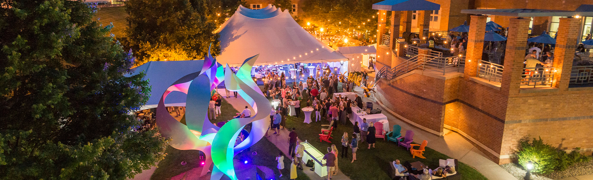 Aerial view of event at night on campus