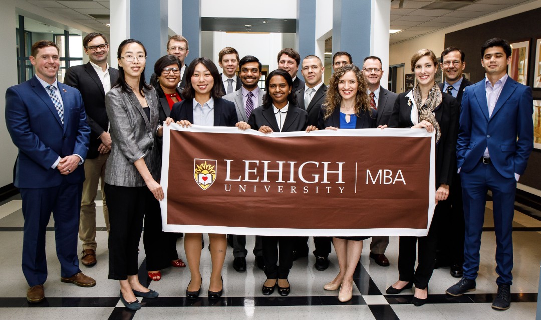Group of MBA students with Lehigh sign