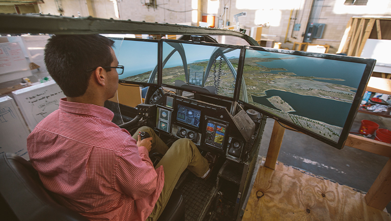 A male student using a flight simulator