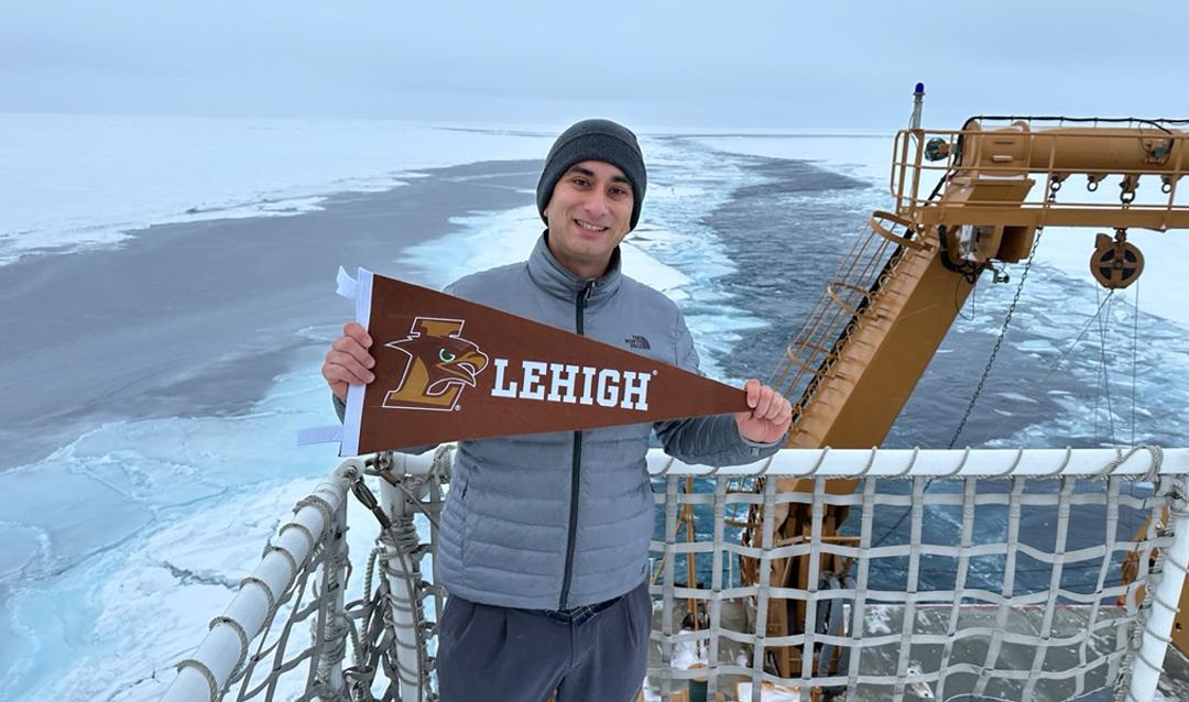 Eugene Vivino ’16 holds a Lehigh sign at the Arctic