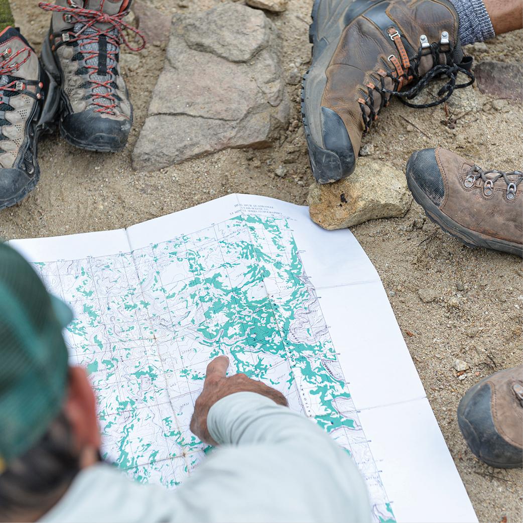 Close up of a person pointing at a map