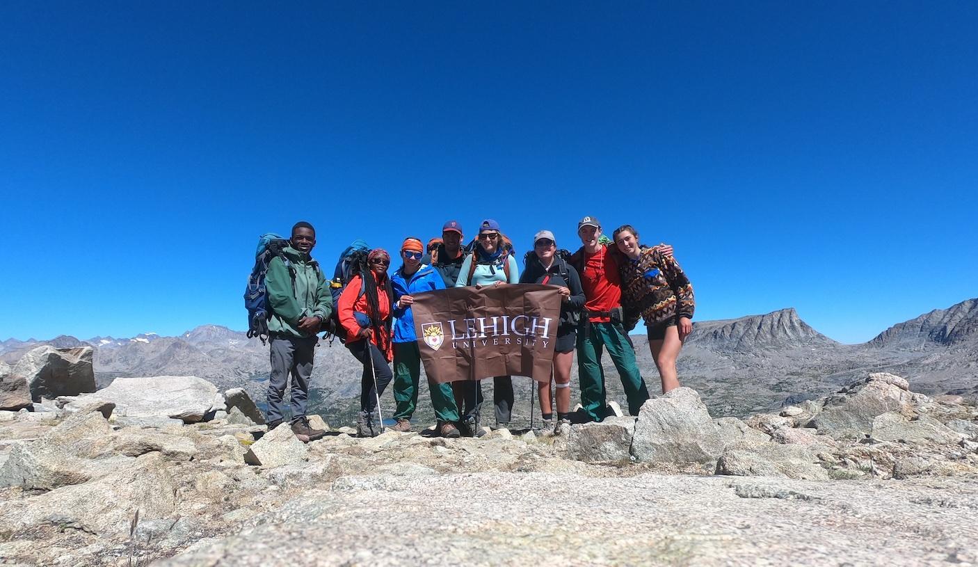 Group of people at the top of a mountain