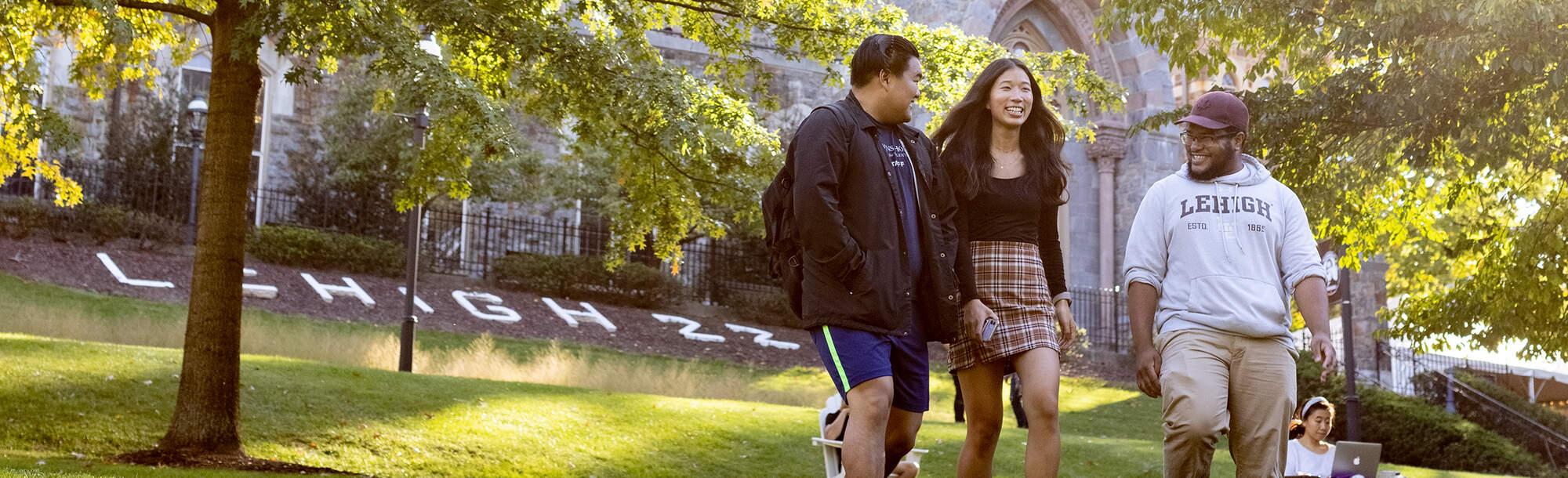 Three students walking on campus