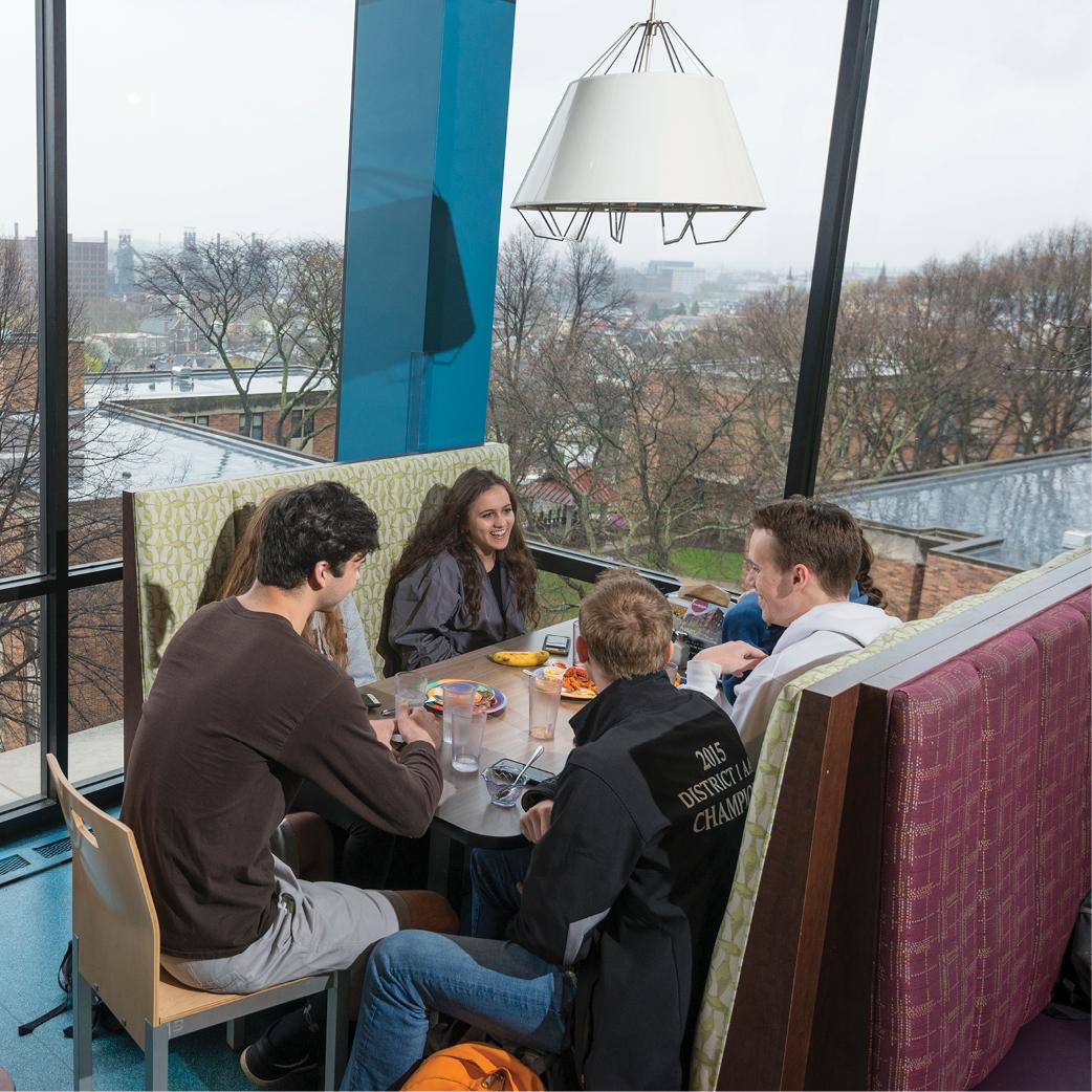 A group of students sitting in a booth at a restaurant