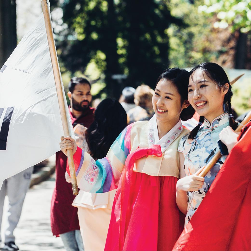 Two women dressed in traditional Korean hanbok at a cultural event.