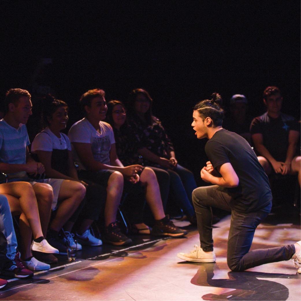 A male student performing on a stage