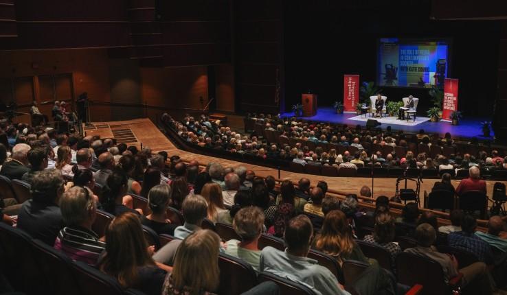 Full Baker Hall with Couric and Helble on stage