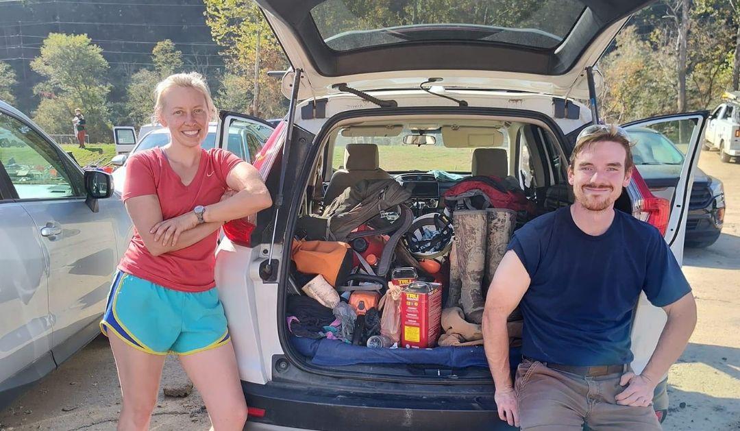 Ashley Kreitz ’15 and Gerik Bensing ’14 stop by Kreitz’s vehicle to gather supplies needed for their volunteer work. 