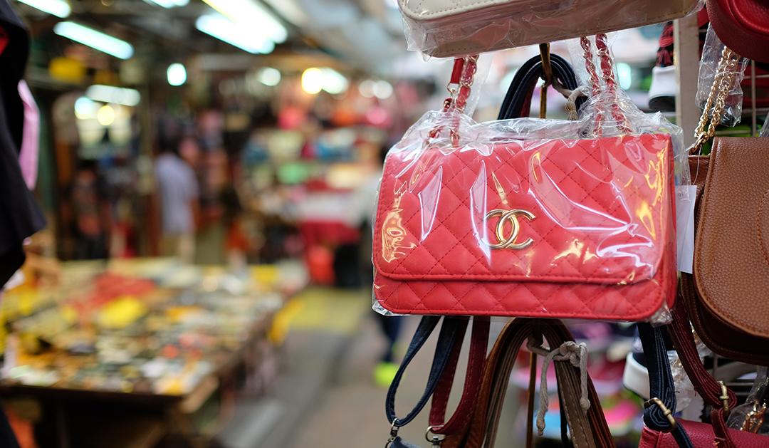 purse hanging on shopping rack in store