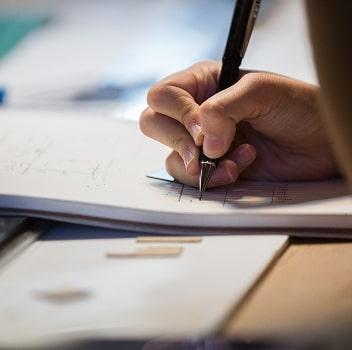 Student writing in notebook