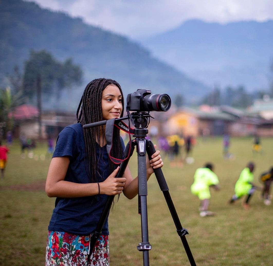 Student with a tripod and camera