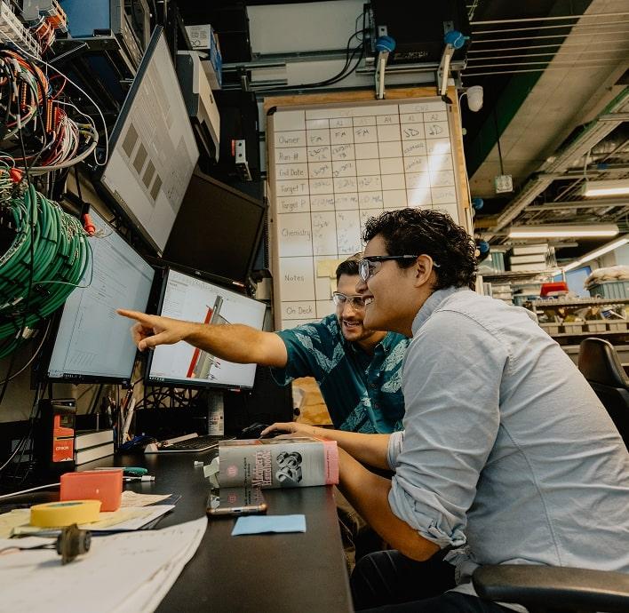 Student and professor at computer station