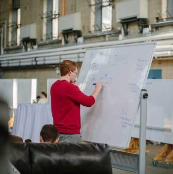 Student writing on a whiteboard