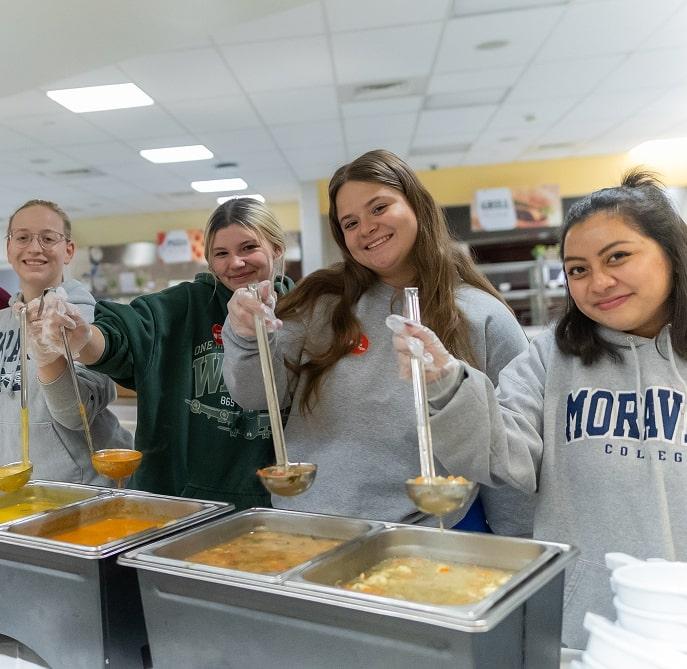 Four volunteers at a soup kitchen
